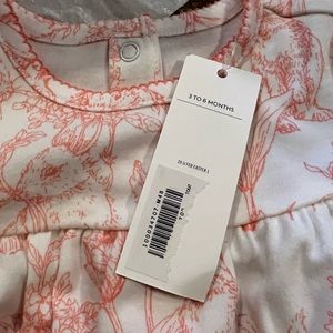 3-6 month one piece pajamas with button closure.